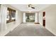 Inviting living room with plush carpeting, neutral tones, large windows, and a ceiling fan at 1868 N Hawthorne Ln, Indianapolis, IN 46218