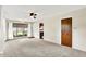 Bright living room featuring neutral walls, ceiling fan, and large windows providing natural light at 1868 N Hawthorne Ln, Indianapolis, IN 46218