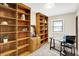 Home office with built-in bookshelves and a dedicated workspace at 1868 N Hawthorne Ln, Indianapolis, IN 46218