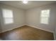 Bright bedroom with modern flooring, fresh paint, and natural light from two large windows at 1902 N Colorado Ave, Indianapolis, IN 46218
