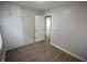 Bedroom with wood floors, built-in storage, and a doorway leading to another room at 1902 N Colorado Ave, Indianapolis, IN 46218
