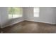 Bright bedroom with modern flooring, fresh paint, and natural light from two large windows at 1902 N Colorado Ave, Indianapolis, IN 46218
