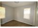 Bedroom with two windows providing ample natural light, featuring wood floors and neutral paint at 1902 N Colorado Ave, Indianapolis, IN 46218