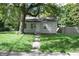 Charming single-story home with vinyl siding and a well-maintained front yard with mature trees at 1902 N Colorado Ave, Indianapolis, IN 46218