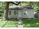 Well-maintained single-story home featuring a tidy front lawn and inviting entryway with a white front door at 1902 N Colorado Ave, Indianapolis, IN 46218