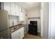 Functional kitchen featuring stainless steel appliances, ample counter space, and white cabinets at 1902 N Colorado Ave, Indianapolis, IN 46218