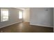 Bright and airy living room with modern flooring, fresh paint, and natural light from two large windows at 1902 N Colorado Ave, Indianapolis, IN 46218