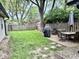 A large backyard with a shed, patio, dining set, grill, fence, and tree at 1917 W Norwood Dr, Muncie, IN 47304