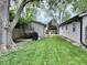 A fenced backyard with a shed, lawn, patio, outdoor table, and grill at 1917 W Norwood Dr, Muncie, IN 47304