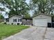 A charming backyard featuring a wooden fence that leads to a detached garage at 1917 W Norwood Dr, Muncie, IN 47304