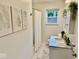 Bright bathroom featuring updated vanity with white marble countertop and fern wall art at 1917 W Norwood Dr, Muncie, IN 47304