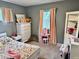 bedroom with flower print bedsheets, white dresser, and pink decor at 1917 W Norwood Dr, Muncie, IN 47304