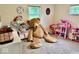 Spacious bedroom with a teddy bear and toys and natural light from two windows at 1917 W Norwood Dr, Muncie, IN 47304