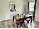 Dining room with a glass table and a decorative mirror reflecting the living room at 1917 W Norwood Dr, Muncie, IN 47304