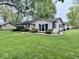 An inviting single-story home featuring a well-manicured lawn with tasteful landscaping at 1917 W Norwood Dr, Muncie, IN 47304