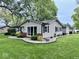 Exterior shot showcasing the house with a well-kept lawn, landscaping, and a detached garage at 1917 W Norwood Dr, Muncie, IN 47304