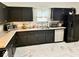 Another view of kitchen with black cabinets and modern, stainless steel appliances at 1917 W Norwood Dr, Muncie, IN 47304