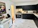 Modern kitchen with stainless steel appliances and sleek black cabinets at 1917 W Norwood Dr, Muncie, IN 47304