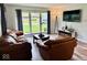 Cozy living room showcasing wood-look floors, natural light, and comfortable seating arrangement at 1917 W Norwood Dr, Muncie, IN 47304