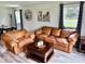 Inviting living room showcasing wood-look floors, comfortable seating, and a coffee table at 1917 W Norwood Dr, Muncie, IN 47304