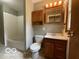 Bathroom with tub shower combo, wooden cabinet, and tiled floor at 1998 Crescent St, Franklin, IN 46131