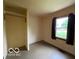Bright bedroom featuring a window with a view and functional closet space at 1998 Crescent St, Franklin, IN 46131