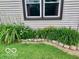 Landscaped lawn with window and rock border around flower beds at 1998 Crescent St, Franklin, IN 46131