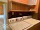 Convenient laundry room featuring washer, dryer, and built-in shelves at 1998 Crescent St, Franklin, IN 46131