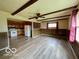 Open living area with kitchen, beamed ceiling, and modern vinyl flooring at 1998 Crescent St, Franklin, IN 46131