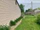 Side yard featuring a partial fence and surrounding greenery at 1998 Crescent St, Franklin, IN 46131