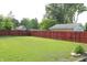 Backyard with a large green lawn that is fully enclosed by a wooden fence at 202 S Church St, Brooklyn, IN 46111