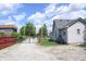 Spacious gravel parking and fenced backyard with grass area; single Gathering residence at 202 S Church St, Brooklyn, IN 46111