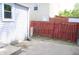 View of the backyard featuring concrete patio and red wood fence at 202 S Church St, Brooklyn, IN 46111