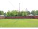 Large backyard featuring a well-maintained lawn surrounded by a wooden privacy fence at 202 S Church St, Brooklyn, IN 46111