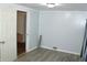Bedroom featuring new plank flooring and painted walls with a doorway leading to another room at 202 S Church St, Brooklyn, IN 46111