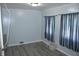 Bedroom featuring blue walls, plank flooring, curtains and a doorway at 202 S Church St, Brooklyn, IN 46111