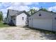 The exterior of the house features light siding, a new gray roof and a detached garage at 202 S Church St, Brooklyn, IN 46111