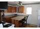 Eat-in kitchen featuring an oven, bar seating, and dated cabinets at 202 S Church St, Brooklyn, IN 46111