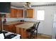 Efficient kitchen design with oak cabinets, breakfast bar and modern appliances at 202 S Church St, Brooklyn, IN 46111