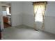 Bright and airy living room featuring a window, paneled walls, and carpeted floors at 202 S Church St, Brooklyn, IN 46111
