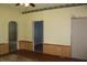 Inviting living room with wood floors, wainscoting and multiple entrances at 202 S Church St, Brooklyn, IN 46111