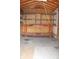 An inside view of the shed that features shelving with empty space for storage at 202 S Church St, Brooklyn, IN 46111
