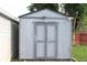 Exterior view of the wooden storage shed with a double door at 202 S Church St, Brooklyn, IN 46111