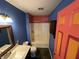 Bathroom with tub and shower combination with blue and red walls at 2133 10Th St, Columbus, IN 47201