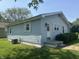 Side view of a light blue one-story home with well-placed windows and a neat lawn at 2133 10Th St, Columbus, IN 47201