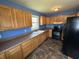 A well-lit kitchen includes ample cabinetry, black appliances, and durable countertops at 2133 10Th St, Columbus, IN 47201