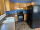 Functional kitchen featuring oak cabinets, black appliances, and durable countertops at 2133 10Th St, Columbus, IN 47201
