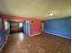 Spacious living room featuring wood floors, blue accent walls, and an open layout to the kitchen at 2133 10Th St, Columbus, IN 47201