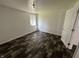 Bedroom with updated floors, white walls, and an open door at 2310 E Raymond St, Indianapolis, IN 46203
