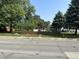 Charming exterior view, highlighted by mature trees, a cute fence, a mailbox with the property's address, and a shed at 2310 E Raymond St, Indianapolis, IN 46203